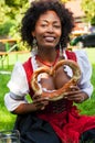 Woman in Dirndl with Bavarian Pretzl