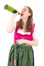 Woman in dirndl drinking some bottles of wine