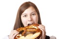 Woman in Dirndl eating Oktoberfest Pretzel