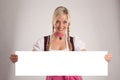 Woman with dirndl holds an empty signboard