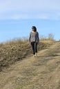 Woman on dirt path enjoying the sun Royalty Free Stock Photo