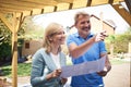 Mature Woman Discusses Plan With Landscape Gardener