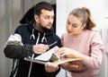 Woman discussing apartment lease agreement with landlord Royalty Free Stock Photo