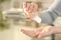 Woman disinfecting hand with sanitizer gel rub