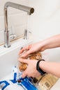 Woman disinfecting products.