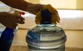 The woman disinfects the carboy