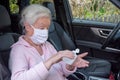 Woman disinfects her hands in car Royalty Free Stock Photo