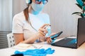 Woman disinfects the surface of the phone