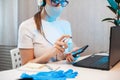 Woman disinfects the surface of the phone