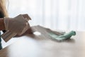 Woman disinfects table with spray disinfectant liquid Royalty Free Stock Photo