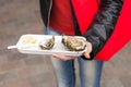 Woman displaying an opened fresh oyster