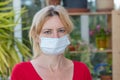 Woman with disposable protective face mask