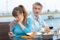 Woman disregarding partner during meal