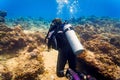 Woman diver at tropical coral reef scuba diving in tropical ocean Royalty Free Stock Photo