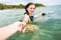 Woman with diving googles dragging partner to the sea Royalty Free Stock Photo