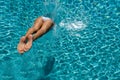 Woman diving at luxury five stars spa resort in the swimming pool