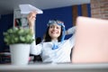 Woman in diving mask launching paper plane at office Royalty Free Stock Photo