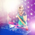 Woman dj, headphones and listen in night club for party with turntable, neon lights and lens flare. Gen z female person Royalty Free Stock Photo