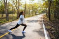 A woman do stretching legs before running in city park Royalty Free Stock Photo