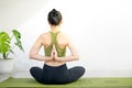 Woman doing yoga on the green yoga mat for meditite and excercise in the home Royalty Free Stock Photo