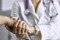 Woman doctor calms patient and holds hand Royalty Free Stock Photo