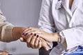 Woman doctor calms patient and holds hand Royalty Free Stock Photo
