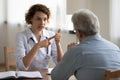 Woman doctor consulting senior patient at medical visit in hospital Royalty Free Stock Photo