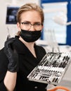 Woman doctor dentist surgeon with medical tools standing in dental