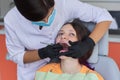 Woman doctor dentist treating teeth to girl patient in dental office Royalty Free Stock Photo