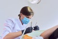 Woman doctor dentist treating teeth to girl patient in dental office Royalty Free Stock Photo