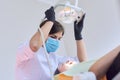 Woman doctor dentist treating teeth to girl patient in dental office Royalty Free Stock Photo