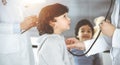 Woman-doctor examining a child patient by stethoscope in sunny clinik. Cute arab toddler at physician appointment Royalty Free Stock Photo