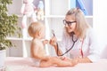 Doctor examining little baby with stethoscope in clinic. Baby health concept Royalty Free Stock Photo