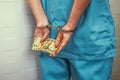 Woman doctor handcuffed. Criminal medic woman hands locked in handcuffs. Bribe