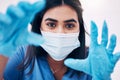 Woman, doctor and hands with face mask for healthcare, exam or busy with surgery at the hospital. Female medical expert