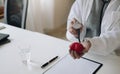 Woman doctor hands holding stethoscope to checking red heart model,Good health good life,World heart dayHealth care checking Royalty Free Stock Photo