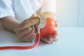 Woman doctor hands holding stethoscope to checking red heart from patient,Health care checking concep Royalty Free Stock Photo