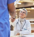 Woman, doctor and handshake with nurse for teamwork, partnership or thank you for healthcare service, meeting or