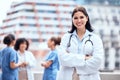 Woman, doctor and happy portrait outdoor with arms crossed at hospital, clinic or colleagues on rooftop for a break Royalty Free Stock Photo