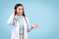 Woman doctor with headset ready for teleconsultation Royalty Free Stock Photo