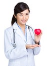 Woman doctor with heart shape ball