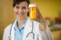 Woman Doctor holding bottle of pills