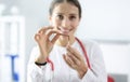 Woman doctor holding broken cigarette in clinic closeup Royalty Free Stock Photo