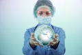 The woman doctor holding earth in globalisation concept