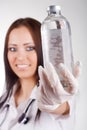 Woman doctor holding a glass bottle Royalty Free Stock Photo
