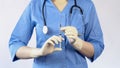 Woman doctor holding syringe going to make an injection to patient, vaccination Royalty Free Stock Photo