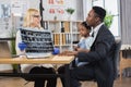 Woman doctor holding x-ray scan, talking with black-skinned father with cute mixed race daughter Royalty Free Stock Photo