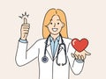 Woman doctor from in hospital with heart in hand smiling and showing thumb up