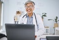 Woman doctor, laptop and happy in hospital office while working online for consultation or research. Medical Royalty Free Stock Photo