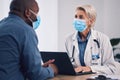 Woman, doctor and laptop with patient in consultation, checkup or help and advice at hospital. Female person, medical or Royalty Free Stock Photo